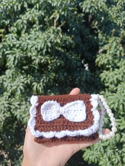 The same pocket purse design in a rich brown and white combination, showing the versatility of the pattern.