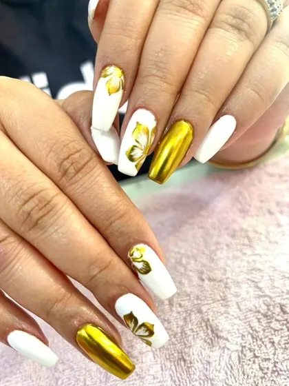 A beautiful set of white coffin nails with gold chrome and hand-painted gold flower accents.
