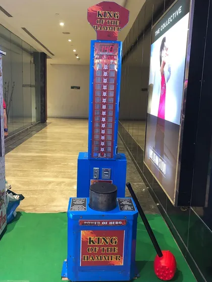 This is our classic 'King of the Hammer' high-striker game, set up and ready for action. It is a durable and reliable attraction that consistently draws a crowd at fairs, carnivals, and large-scale parties.