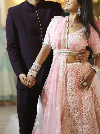 For your wedding events, you can rent a complete couple's set, including this intricately embroidered pink lehenga and a complementing blazer for him.