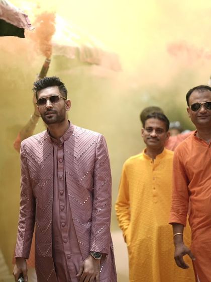 Walking through a cloud of colors, making sure the celebration is as grand and vibrant as the couple's love story.