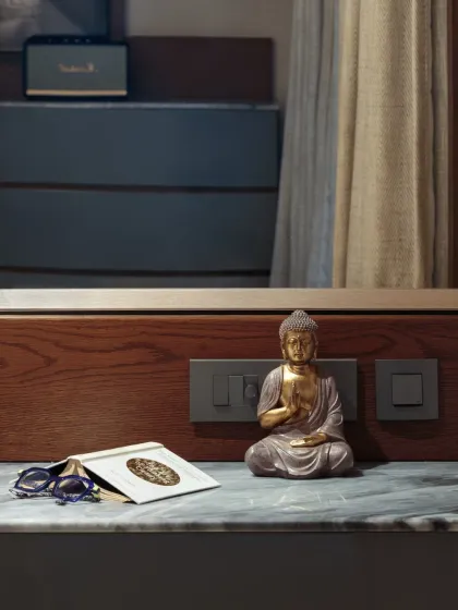 A small vignette on the master bedroom console, where a Buddha statue brings a sense of peace and stillness. These personal touches make a space feel like a true sanctuary.