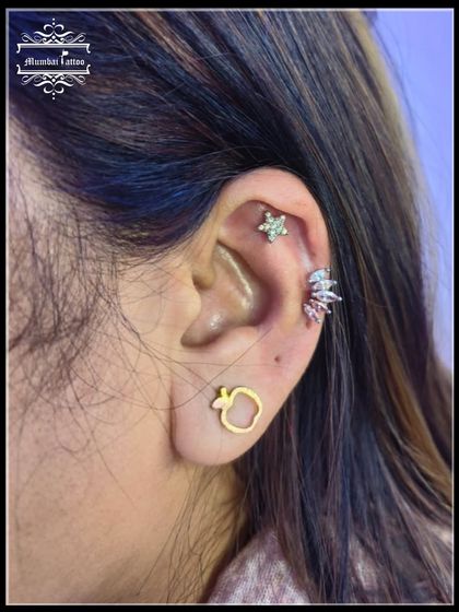 A mid-helix piercing featuring two beautiful studs. We have great offers on all needle piercings, so you can build the ear stack of your dreams.