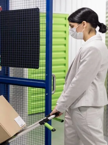 We make it easy for you to manage your inventory. This image shows a business professional effortlessly moving stock into one of our units, highlighting the convenience and accessibility of our facilities for day-to-day operations.