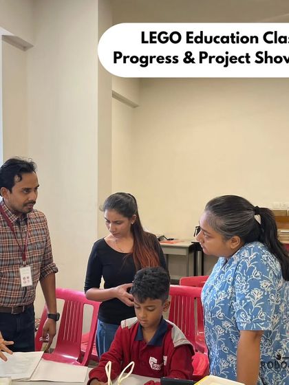 A parent and student discuss his project with our instructor during a showcase event at Vidyashilp Academy. These events allow parents to see their child's progress and understanding of STEM concepts.