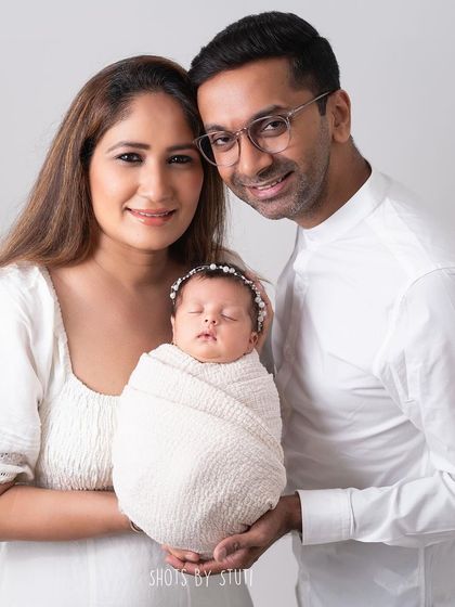 A classic family portrait with a newborn. Everyone is dressed in white for a clean, timeless look that keeps the focus on the love and connection within the family.