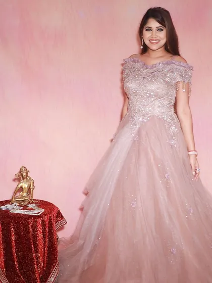 Live your princess moment in this beautiful cold-shoulder pastel pink ball gown. It's a dreamy choice for an engagement or reception.