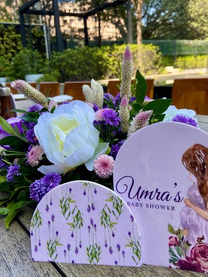 The custom-designed stationery for Umra's lavender-themed baby shower, perfectly matching the floral centerpieces on the tables.