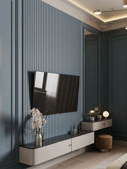 A side view of the blue fluted TV wall and dressing table combination. This angle highlights the clean lines and the elegant wall sconce that provides task lighting for the vanity area.