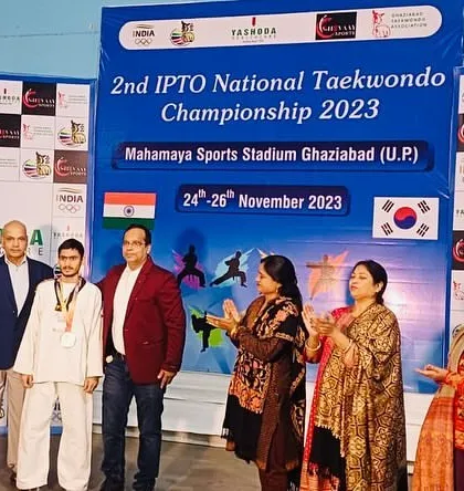 A young male student stands proudly with his medal at the national championship. I train both boys and girls to become confident and skilled martial artists.
