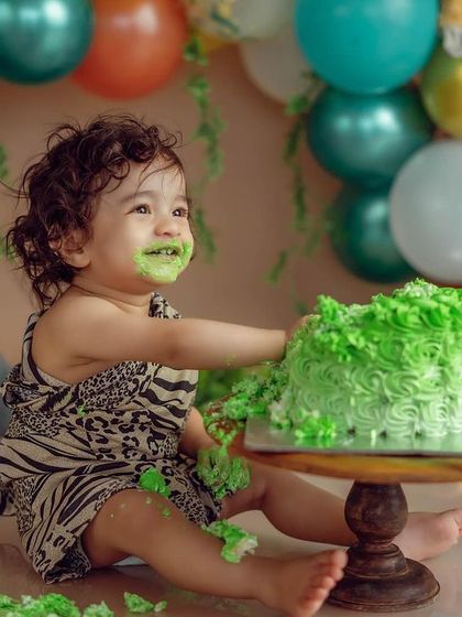 A close-up of the cake-covered grin. These are the real, silly moments that make cake smash photography so special and memorable for parents.