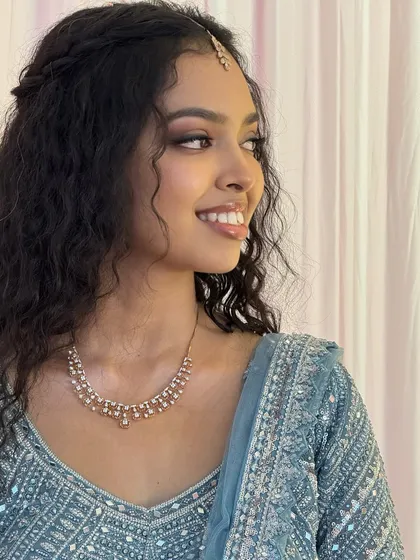 Another beautiful, smiling portrait of Sushmita. The makeup is designed to look stunning in person and on camera, highlighting her best features.