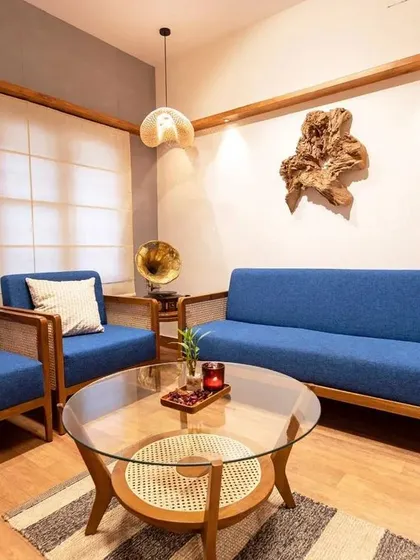 I believe furniture should bring people together. This living room set, featuring a 5-seater teak wood sofa and armchairs with vibrant blue upholstery and rattan details, was crafted to create a space that is both elegant and incredibly inviting.