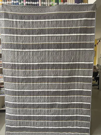 The striped backing fabric of the Pinwheel quilt.