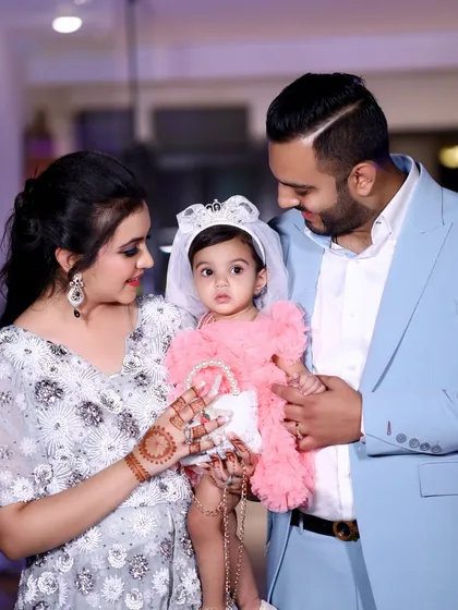 A tender moment as the parents look lovingly at their daughter. My family function videography and photography focus on these small, emotional details.