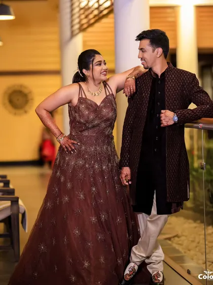 A relaxed and stylish pose from the same couple, showcasing their evening wear in a different setting.