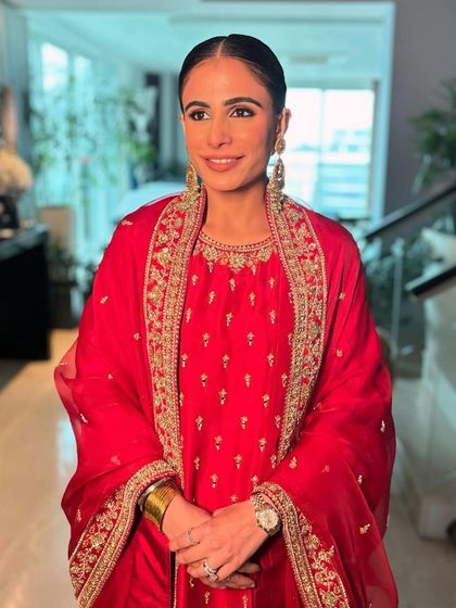 A beautiful, happy portrait. The makeup is minimal, focusing on flawless skin and bright eyes.