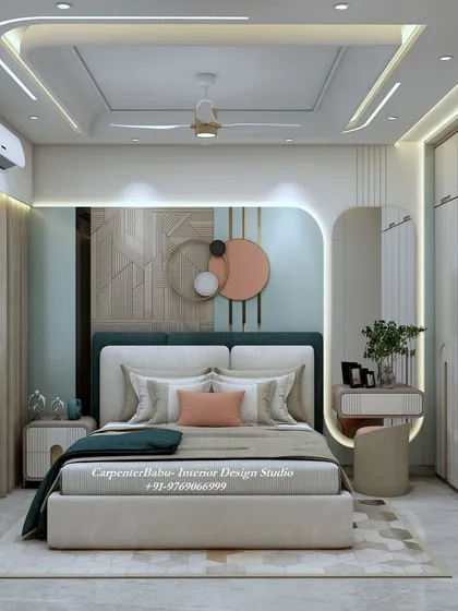 This bedroom uses a soft color palette of sage green and peach. The headboard wall features modern abstract art, and the full-wall wardrobe provides ample storage.
