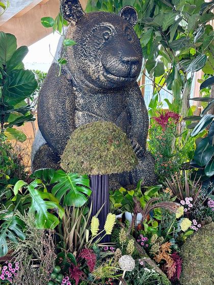 A close-up of the glittery black bear statue, a unique and striking centerpiece for the event.