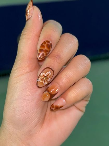 This design features a warm, earthy palette with hand-painted animal prints and a delicate floral accent. The mix of patterns creates a stylish and cohesive look.