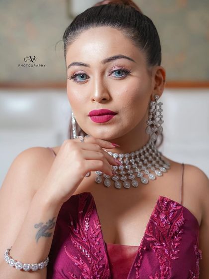 A confident and glamorous portrait of the bride on her engagement day, looking directly at the camera with a captivating gaze.