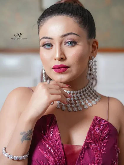 A confident and glamorous portrait of the bride on her engagement day, looking directly at the camera with a captivating gaze.