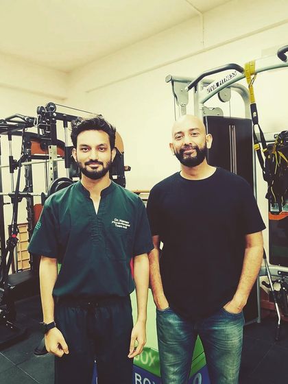 A photo with a happy client after a successful treatment program with Dr. Naman. Seeing our clients regain their health and well-being is the most rewarding part of our work.