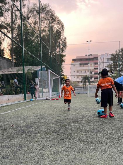 A young player runs with enthusiasm during a fun training game.