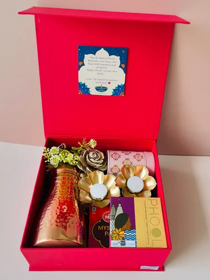The red Diwali hamper with its lid open, showing the custom message card I can add inside. It’s a great way to add a personal note to your gift.