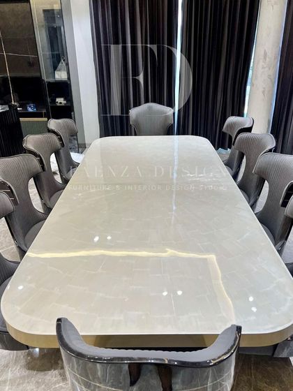 A top-down view of this magnificent dining table, showcasing the beautiful natural patterns of the backlit onyx top. The smooth, curved edges add a soft and elegant touch to the design.