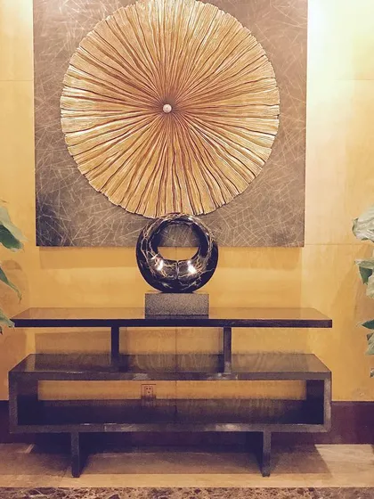 Here is another one of my console tables, this one with a clean, linear design, providing a sleek surface for decor. It shows how I can create pieces that complement my clients' existing art and accessories.