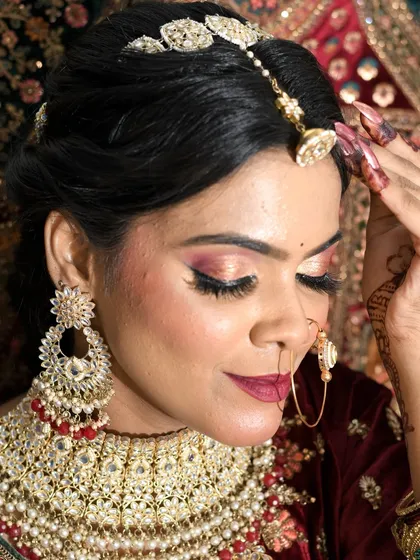 Another angle of the bridal look, showcasing the intricate hairstyle and detailed makeup.