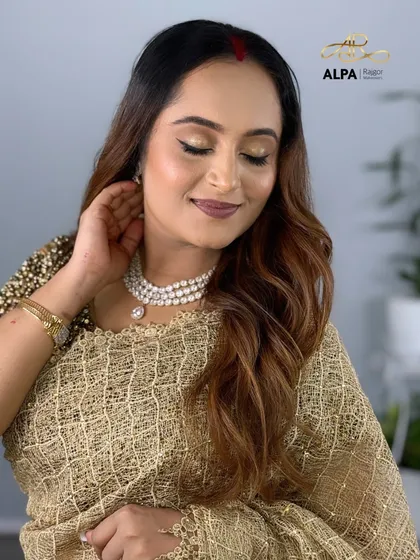 A close-up focusing on the soft golden eye makeup and the perfectly defined eyebrows.