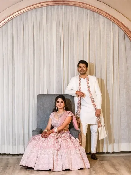 "I want to be with you until my last page." A modern, stylish portrait of the couple, with the groom standing protectively by his seated bride, creating a powerful and fashionable image.