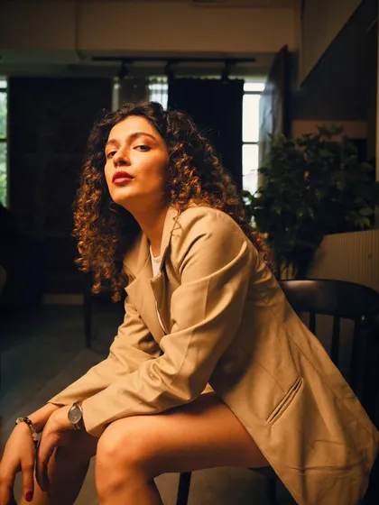 A powerful, low-angle shot that conveys confidence. The natural light from the window in the background adds a nice highlight.