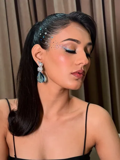 A close-up of the rhinestone eye makeup, showing the delicate placement and the beautiful shimmer.