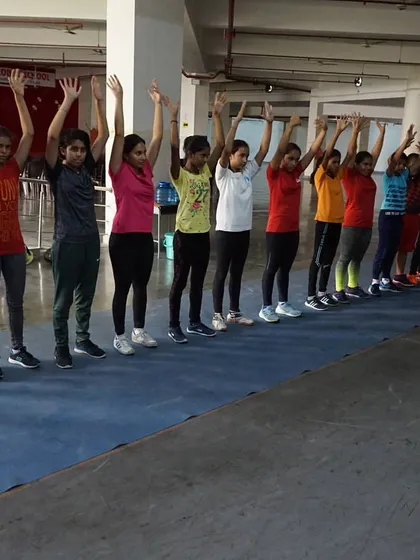 Campers participating in a group stretching exercise. We teach the importance of warming up and cooling down from a young age.