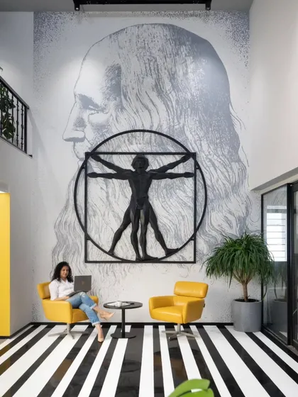 Art can be playful and profound at the same time. For this creative design office, I combined a classic Da Vinci portrait with a modern metal sculpture of the Vitruvian Man. It’s a nod to the masters that inspires the young design team daily.