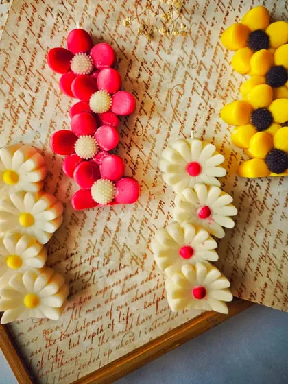 My Floral Symphony Candles, arranged on a rustic background. These flower-shaped beauties are a charming and colorful addition to any decor theme or Diwali hamper.