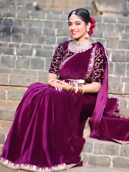 A regal portrait of the bride seated on stone steps, looking like a queen.