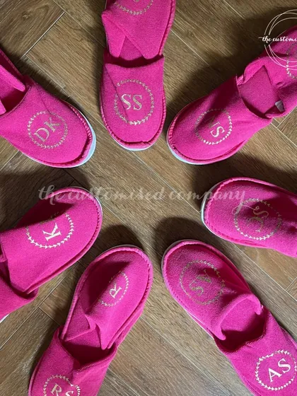 Let your bridesmaids walk beside you in comfort and style. These vibrant pink slippers are personalized with each of their initials, making for a cute and practical gift.