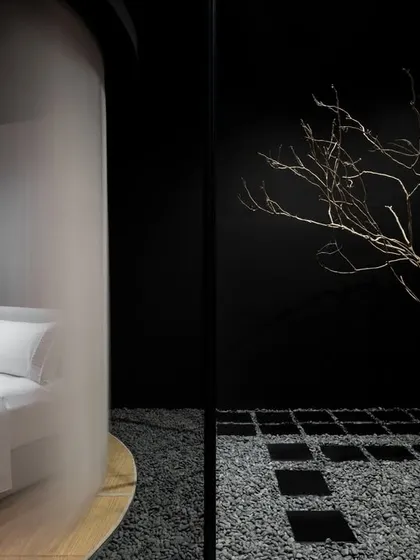 This composition illustrates our core concept of discovery. The product, a finely dressed bed, is partially revealed through a translucent veil, juxtaposed with the sculptural, organic form of a bare tree at the entrance, blending the commercial purpose with a natural, calming aesthetic.