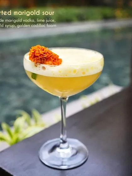Our Inverted Marigold Sour is a celebration of floral flavors. We use sous vide marigold vodka, fresh lime juice, and a delicate marigold syrup, topped with golden cadillac foam. The result is a bright, aromatic, and visually stunning cocktail.