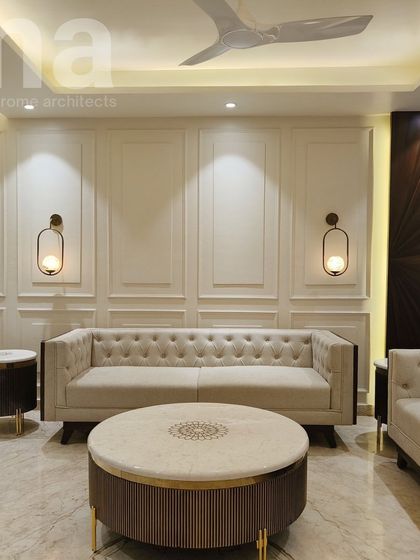 We combined classic elements like wainscoting and a Chesterfield sofa with modern touches like rattan accents and a marble coffee table. This mix of textures and styles creates a timeless and elegant living room.