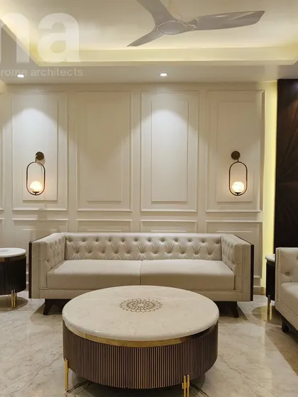 We combined classic elements like wainscoting and a Chesterfield sofa with modern touches like rattan accents and a marble coffee table. This mix of textures and styles creates a timeless and elegant living room.