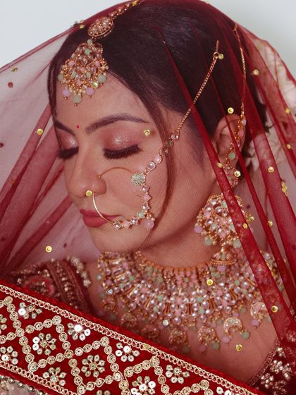 A serene bridal portrait with eyes closed, highlighting the soft, shimmery eyeshadow and perfectly blended foundation.