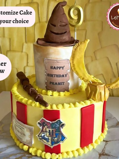 Accio cake! A magical Harry Potter cake featuring the Sorting Hat, a golden snitch, and a wand. The Gryffindor colors and Hogwarts crest make this the perfect centerpiece for any Potterhead's birthday.