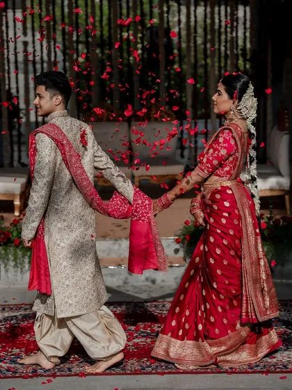 We live for moments like these. A grand exit under a shower of petals for Laksha and Partha, perfectly capturing the magic of their Sabyasachi and Tarun Tahiliani ensembles at the breathtaking Amitarasa venue.