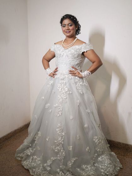 This white ball gown with floral applique is a classic choice for any formal event. It makes you feel like royalty.