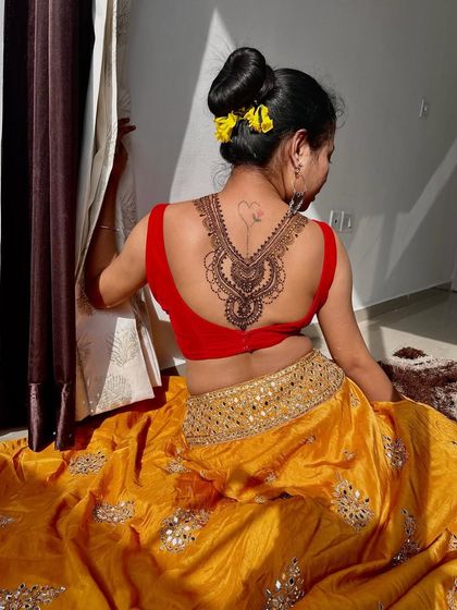 This photo shows the back mehndi from a different angle, highlighting the delicate lines and patterns.